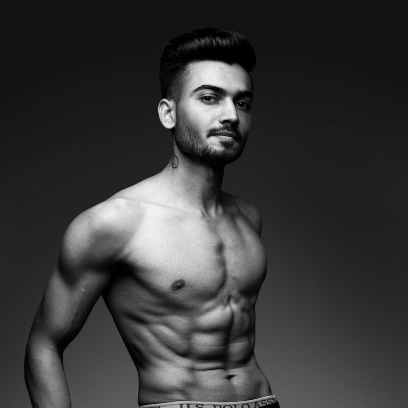 topless man in black pants
